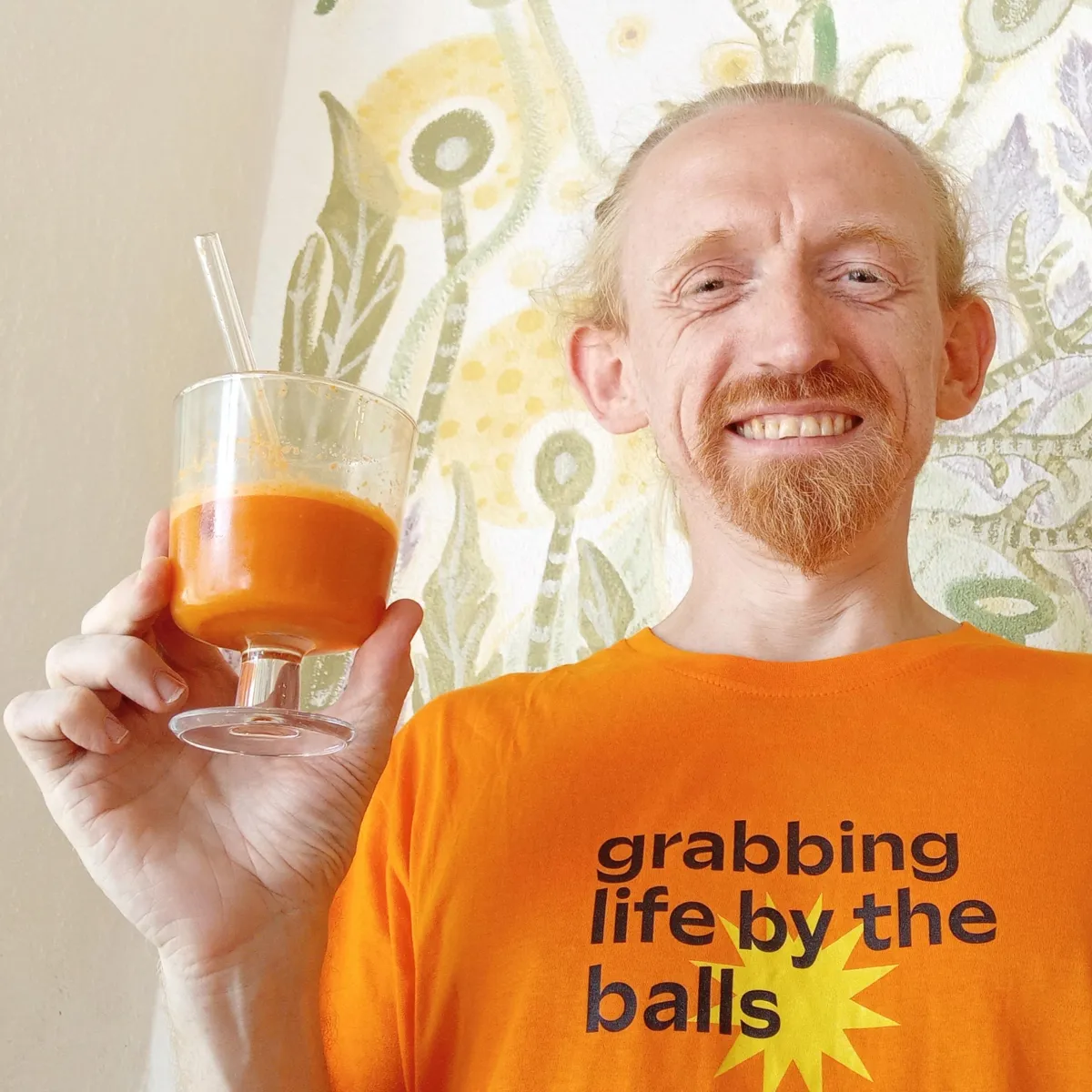 Rory smiling with a fresh carrot juice